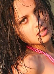 Very sexy brunette teen bending naked on the seastone